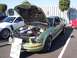 2002 Ford Mustang - A modified Ford Mustang with its hood up is displayed next to another Mustang at an outdoor event.