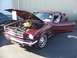 2002 Ford Mustang - A classic Mustang is displayed with its hood and door open, revealing the engine bay. A second vehicle is parked nearby.