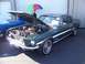 2002 Ford Mustang - A 1967 Ford Mustang coupe is displayed with its hood open, parked next to another vehicle.