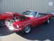 2002 Ford Mustang - A red 1967 Ford Mustang convertible is displayed with its hood open, revealing the engine compartment.