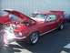 2002 Ford Mustang - A red classic car is displayed with its hood and trunk open, revealing the engine and interior.