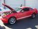2002 Ford Mustang - A red 2007 Ford Mustang GT 500 is displayed with its hood open, revealing the engine compartment.