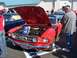 2002 Ford Mustang - A red classic Ford Mustang convertible is displayed with its hood open, revealing the engine bay.