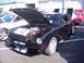2002 Ford Mustang - A classic black Ford Mustang is displayed with its hood open, revealing the engine bay.