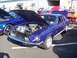 2002 Ford Mustang - A classic 1968 Ford Mustang GT is displayed with its hood open, alongside a newer model Mustang.