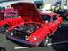 2002 Ford Mustang - A red classic Ford Mustang is displayed with its hood open, revealing the engine bay.
