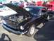 2002 Ford Mustang - This black 1965 Ford Mustang coupe displays its engine with the hood open, a prominent '347' badge on the front fender.