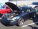 2002 Ford Mustang - Dark blue 2002 Ford Mustang coupe on display with hood open, parked next to a red car.
