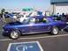 2002 Ford Mustang - A blue classic Ford Mustang is parked at a car show with its hood open.