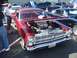 2002 Ford Mustang - A custom 1966 Ford Fairlane, a prominent supercharger under its hood, is displayed at an outdoor car show.