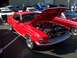 2002 Ford Mustang - Red classic Ford Mustang parked at an outdoor car show, hood open to display the engine.