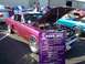 2002 Ford Mustang - A custom 1965 Mustang Fastback is displayed with its hood open at an outdoor event.