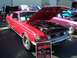 2002 Ford Mustang - A red 1968 Ford Mustang GT390 is displayed with its hood open, revealing the engine bay.