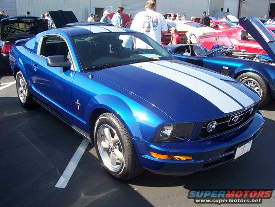 Blue Mustang with white racing stripes, 3/4 front view