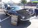 2002 Ford Mustang - Black 1968 Ford Mustang California Special displayed with its hood open and an informational sign.