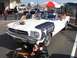 2002 Ford Mustang - A white 1965 Ford Mustang convertible is displayed with a blue fender cover and a toy car in front.