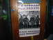 1997 Ford Crown Victoria - Poster with armed men and political slogans is taped to a wooden door.