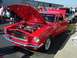 2002 Ford Mustang - A classic red Ford Mustang is displayed with its hood open at a car show event.