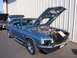 2002 Ford Mustang - Classic blue Ford Mustang with its hood open, parked next to another vehicle.