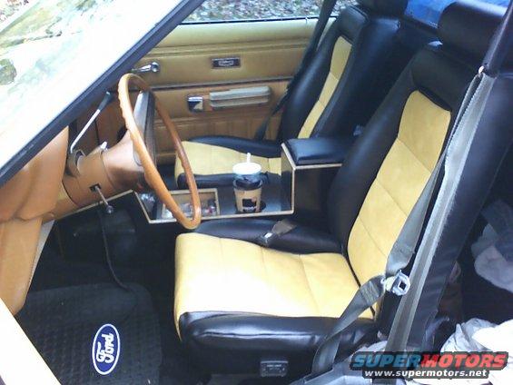 1979 Ford Ranchero interior with black and yellow seats, wooden steering wheel, and a Ford floor mat