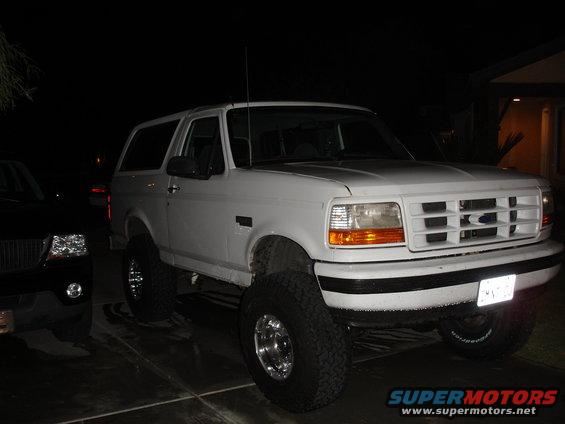 White 1996 Ford Bronco with lifted suspension, front 3/4 view