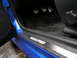 2003 Mazda Protege - The interior door sill of a blue vehicle displays the "MAZDASPEED" branding, with pedals visible in the footwell.