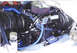 1979 Ford Bronco - The engine bay of a 1979 Ford Bronco shows a Ford engine with custom blue hoses and a chrome air cleaner.