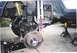 1979 Ford Bronco - Vehicle suspension and undercarriage components are visible while the vehicle is supported by jack stands.