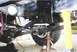 1979 Ford Bronco - The vehicle's undercarriage is visible, supported by jack stands and a yellow support.