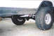 1979 Ford Bronco - Close-up view of the undercarriage and tires of a modified off-road vehicle.