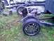 2002 Ford Crown Victoria - The chassis and frame of a vehicle are visible, with chrome wheels on the ground.