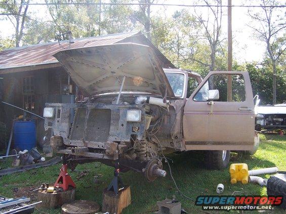 1980 Ford Bronco with hood open, front end disassembled, on jack stands