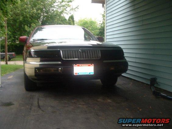 Front view of a 1992 Mercury Grand Marquis parked next to a house