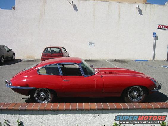 Red 1962 Jaguar XKE coupe, side view, wire wheels