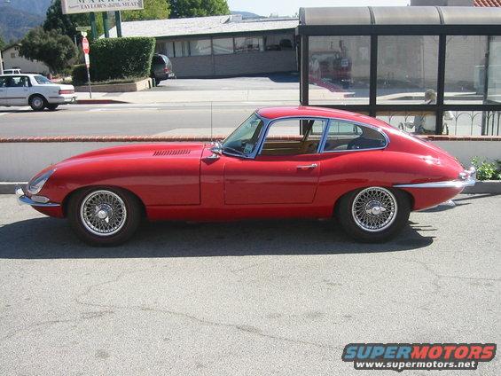 Red 1962 Jaguar XKE coupe, side view