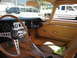 1962 Jaguar XKE - The interior of a classic car is shown, with other vehicles visible through the windows.