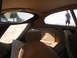 1962 Jaguar XKE - View from inside a 1962 Jaguar XKE, showing the tan interior and distinctive large rear window.