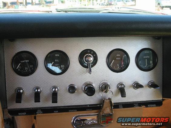 Dashboard with water, oil, fuel, and amps gauges. Ignition switch and keys are visible