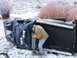 1992 Ford Ranger - A person inspects an overturned pickup truck in a snowy, rural landscape.