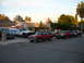 1992 Ford Explorer - Several vehicles, including a red 1992 Ford Explorer, are parked along a residential street.