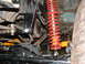 1994 Jeep YJ - Suspension upgrade components visible on a Jeep YJ, including a red coilover shock.