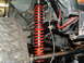 1994 Jeep YJ - Detail shot of off-road suspension components, including a shock absorber and tire.