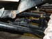1994 Jeep YJ - Close-up view of the undercarriage, focusing on suspension and differential components. The Supermotors.net logo is visible.