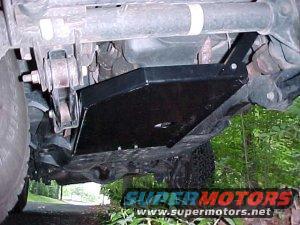 Black underbody skid plate on vehicle frame