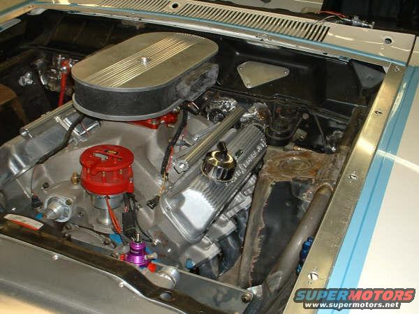 Close-up of a V8 engine with an air cleaner, distributor, and valve covers