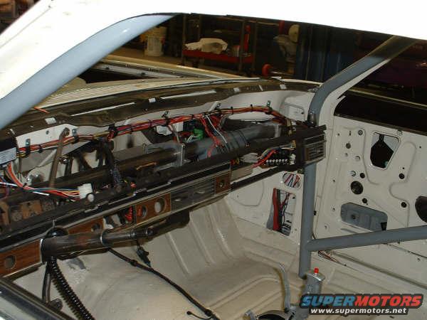 car interior with exposed wiring and roll cage