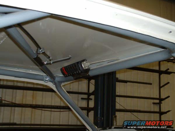Interior roll cage and roof lining with a black electrical component attached