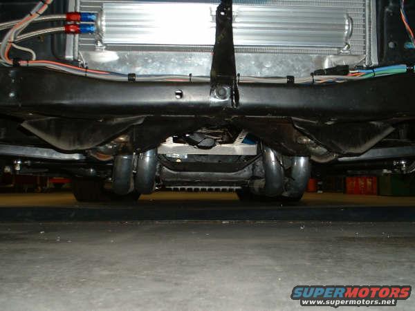 Underbody view of dual exhaust pipes and radiator