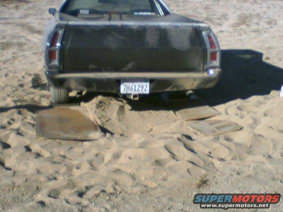 Dark 1972 Ford Ranchero rear view stuck in sand, license plate 7H61292