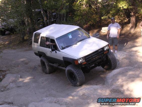 White 1985 Toyota 4Runner on a rocky trail with another vehicle in the background